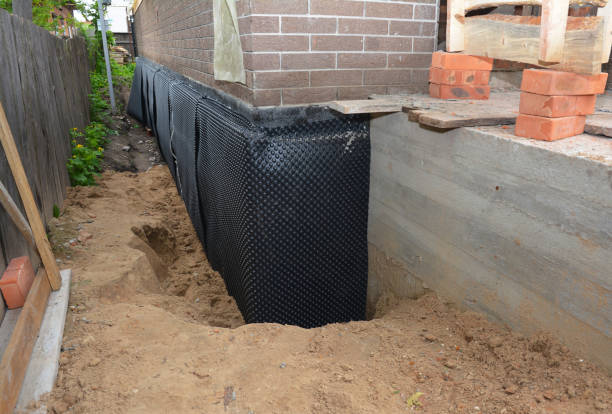 SJ Waterproofing Pros technician performing targeted Waterproofing assessment in Grand Bay, AL